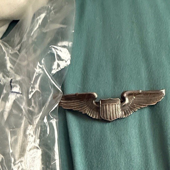 Vintage Winged Shield Pin on Teal Fabric